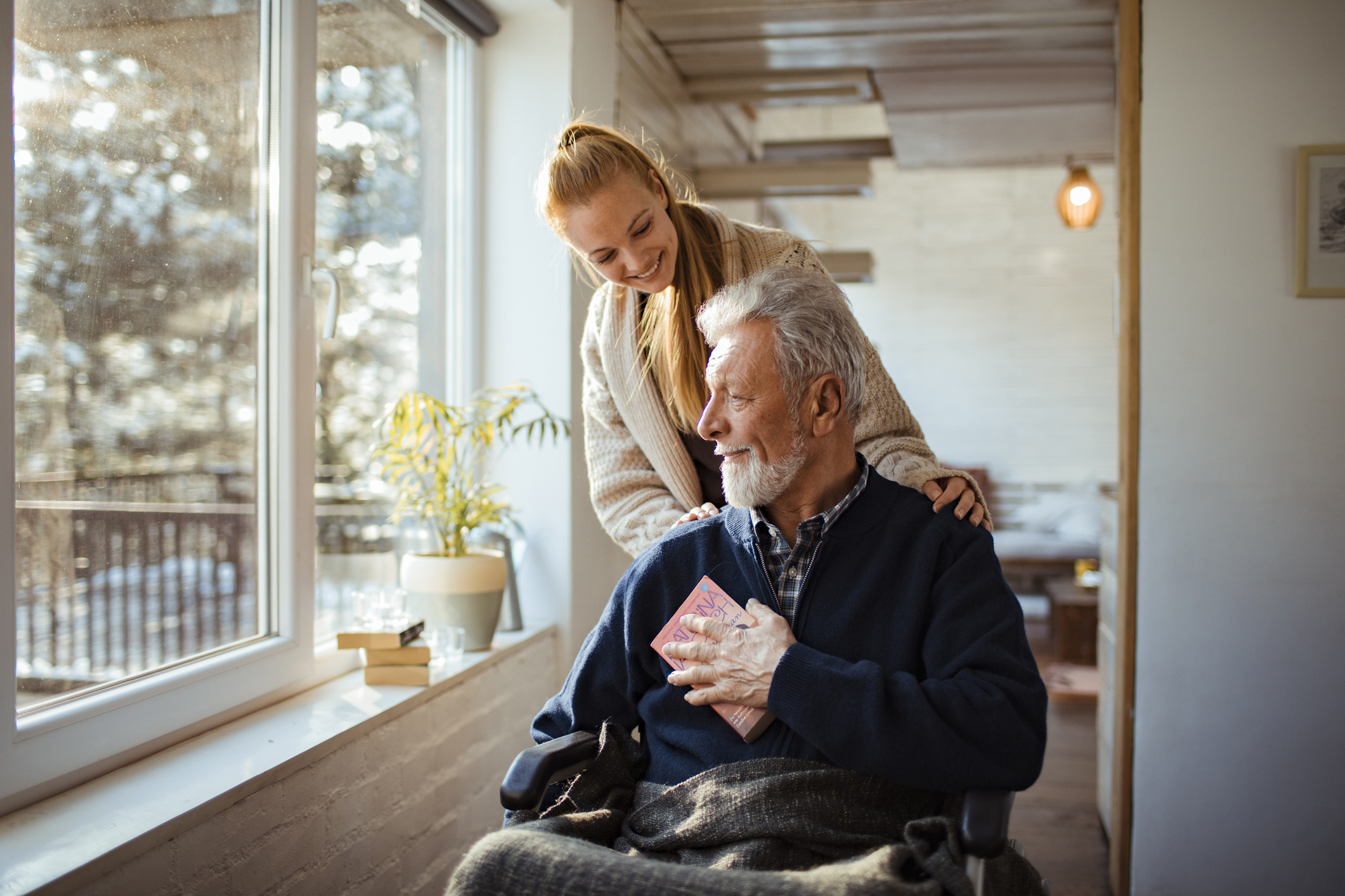 Close up of a granddaughter helping her grandfather around the house