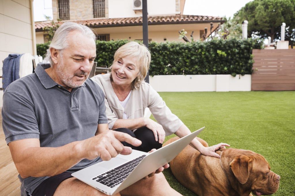 senior couple with dog in backyard image of senior couple with dog in backyard
