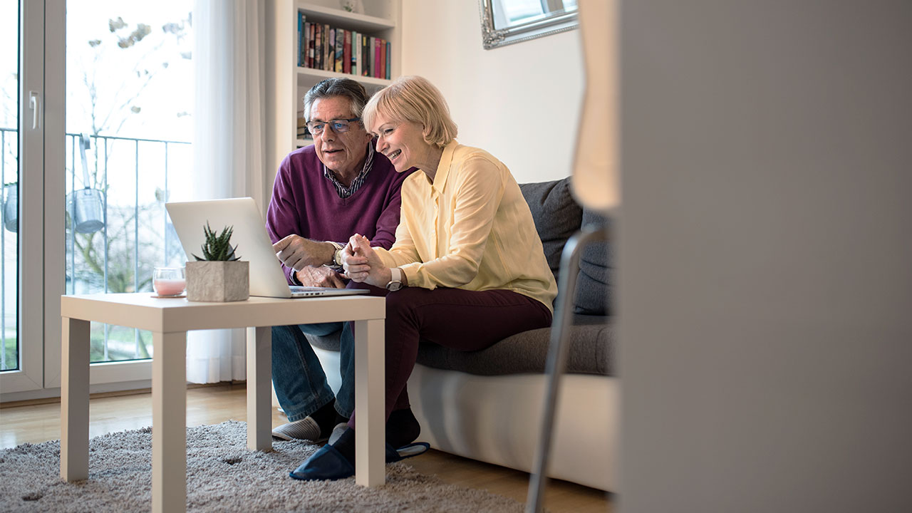 Older couple on laptop talking